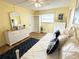 Bright bedroom features yellow walls, wood floor, white furniture and a large window for natural light at 5900 Shore S Blvd # 512, Gulfport, FL 33707