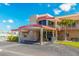 Attractive clubhouse exterior with a covered entrance, stone accents, and a well-maintained landscape at 5900 Shore S Blvd # 512, Gulfport, FL 33707