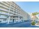 Upscale condo building with multiple levels of balconies and ample parking at 5900 Shore S Blvd # 512, Gulfport, FL 33707
