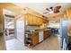 Cozy kitchen with granite counters, light wood cabinets, stainless appliances, and access to an outdoor balcony at 5900 Shore S Blvd # 512, Gulfport, FL 33707