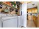 Practical laundry area featuring a washer, dryer, shelving, and adjacent kitchen access for convenience at 5900 Shore S Blvd # 512, Gulfport, FL 33707