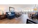 Spacious living room featuring hardwood floors and a comfortable blue sectional sofa at 5900 Shore S Blvd # 512, Gulfport, FL 33707