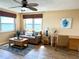Living room with water views, a ceiling fan, and a brown leather sofa at 5900 Shore S Blvd # 512, Gulfport, FL 33707