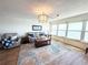 Bright living room with water views, a plush grey sofa, and a decorative turtle rug at 5900 Shore S Blvd # 512, Gulfport, FL 33707