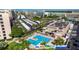 Aerial view of a swimming pool with lounge seating and parking under canopies at 5900 Shore S Blvd # 512, Gulfport, FL 33707