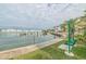 Scenic waterfront view with a bench and palm trees, perfect for relaxation and enjoying the marina at 5900 Shore S Blvd # 512, Gulfport, FL 33707