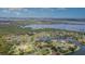 Aerial view showcases the property's prime waterfront location, surrounded by serene waterways and lush greenery at 6120 9Th Avenue Ne Cir, Bradenton, FL 34212