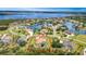 Stunning aerial view of waterfront property showcasing lush landscaping and beautiful neighborhood on a sunny day at 6120 9Th Avenue Ne Cir, Bradenton, FL 34212