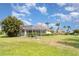 Expansive backyard with a screened-in patio and lush landscaping at 6120 9Th Avenue Ne Cir, Bradenton, FL 34212
