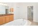 Bathroom featuring a large soaking tub and a granite vanity with cabinets at 6120 9Th Avenue Ne Cir, Bradenton, FL 34212