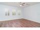 Bedroom featuring wood floors, white shutters, and a ceiling fan at 6120 9Th Avenue Ne Cir, Bradenton, FL 34212