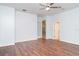 Spacious bedroom with hardwood floors and a ceiling fan at 6120 9Th Avenue Ne Cir, Bradenton, FL 34212