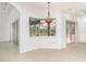 Cozy dining area with corner window, tile flooring, and decorative hanging light fixture at 6120 9Th Avenue Ne Cir, Bradenton, FL 34212