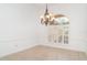 Clean dining room with tile flooring and a chandelier, and arched window with shutters at 6120 9Th Avenue Ne Cir, Bradenton, FL 34212
