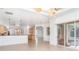 Bright living room showing the kitchen, breakfast nook, and sliding door access to the pool at 6120 9Th Avenue Ne Cir, Bradenton, FL 34212