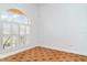 Bright living room features beautiful flooring, large arched window and white shutters at 6120 9Th Avenue Ne Cir, Bradenton, FL 34212