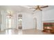 Open-concept living room showcasing tile flooring, an elaborate fireplace, and arched doorways at 6120 9Th Avenue Ne Cir, Bradenton, FL 34212