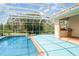 Screened-in pool area with an outdoor kitchen and covered lanai at 6120 9Th Avenue Ne Cir, Bradenton, FL 34212