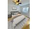 Bright bedroom featuring a queen bed with modern ceiling fan, a window and light gray accents at 6931 Stones Throw N Cir # 5210, St Petersburg, FL 33710