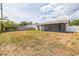 This home has a large backyard with a screen porch and a wood fence at 717 Fairmont Dr, Brandon, FL 33511