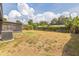 This backyard has a large grassy area, mature trees, and a wood fence at 717 Fairmont Dr, Brandon, FL 33511