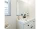 Bright bathroom featuring white vanity, updated fixtures, and a framed mirror adding a modern touch at 717 Fairmont Dr, Brandon, FL 33511
