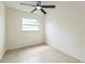 This bedroom features tile floors, a ceiling fan, and a window for natural light at 717 Fairmont Dr, Brandon, FL 33511