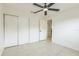 Versatile bedroom featuring a ceiling fan, neutral walls, and closet space at 717 Fairmont Dr, Brandon, FL 33511