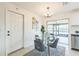 Bright dining area featuring a glass table, view of the backyard patio, and a door to the side yard at 717 Fairmont Dr, Brandon, FL 33511