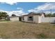 Tan single-story home featuring a gray garage door, driveway, and a well-maintained lawn at 717 Fairmont Dr, Brandon, FL 33511