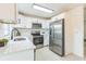 Modern kitchen with white cabinets, stainless steel appliances, and sleek countertops at 717 Fairmont Dr, Brandon, FL 33511