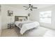 Cozy main bedroom with neutral tones, ceiling fan, and plenty of natural light from a large window at 717 Fairmont Dr, Brandon, FL 33511