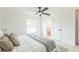 Main bedroom featuring a comfy bed, ceiling fan, and an ensuite bathroom for added convenience at 717 Fairmont Dr, Brandon, FL 33511