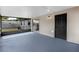 The screened porch has a blue floor and access to the backyard through a black door at 717 Fairmont Dr, Brandon, FL 33511