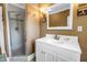 Bathroom featuring a vanity with a sink and a glass-enclosed shower with updated fixtures at 7427 4Th N Ave, St Petersburg, FL 33710