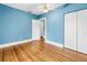 Bright bedroom with hardwood floors, light blue walls, and access to a walk-in closet at 7427 4Th N Ave, St Petersburg, FL 33710