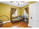 Bedroom with a chaise lounge, vintage sewing machine and original wood floors at 7427 4Th N Ave, St Petersburg, FL 33710