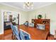Traditional dining room with wood furniture and a view into the living room at 7427 4Th N Ave, St Petersburg, FL 33710