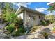 Charming exterior with lush landscaping, unique wall decor, and a peaceful garden setting at 7427 4Th N Ave, St Petersburg, FL 33710