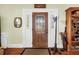 Inviting home foyer features a hardwood floor, front door with glass panes, and decorative accents at 7427 4Th N Ave, St Petersburg, FL 33710
