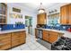 Charming kitchen features wood cabinets, stainless steel appliances, and white tile floor at 7427 4Th N Ave, St Petersburg, FL 33710
