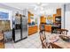Bright kitchen with stainless steel appliances, wooden cabinets and white floors at 7427 4Th N Ave, St Petersburg, FL 33710