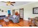 Comfortable living room with hardwood floors, a fireplace, and sliding doors to additional living space at 7427 4Th N Ave, St Petersburg, FL 33710