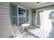Small patio with an outdoor table and chairs near a window and door at 7427 4Th N Ave, St Petersburg, FL 33710