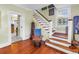 Charming staircase with hardwood steps and white risers, accented by a window and decorative stained glass at 7427 4Th N Ave, St Petersburg, FL 33710