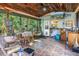 Inviting sunroom with wood ceiling, tile floors, a dining table, and a relaxing seating area at 7427 4Th N Ave, St Petersburg, FL 33710