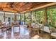 Relaxing sunroom featuring a wooden ceiling, tile floors, and large windows overlooking the backyard at 7427 4Th N Ave, St Petersburg, FL 33710