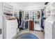 Spacious walk-in closet with custom built-in shelving, drawers, and a decorative area rug at 7427 4Th N Ave, St Petersburg, FL 33710