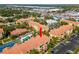 Aerial view of a condo community with a pool, tennis court, and well-maintained landscaping at 10764 70Th Ave # 6210, Seminole, FL 33772