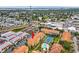Scenic aerial view of a condo complex with a pool and tennis court, with nearby storage units at 10764 70Th Ave # 6210, Seminole, FL 33772